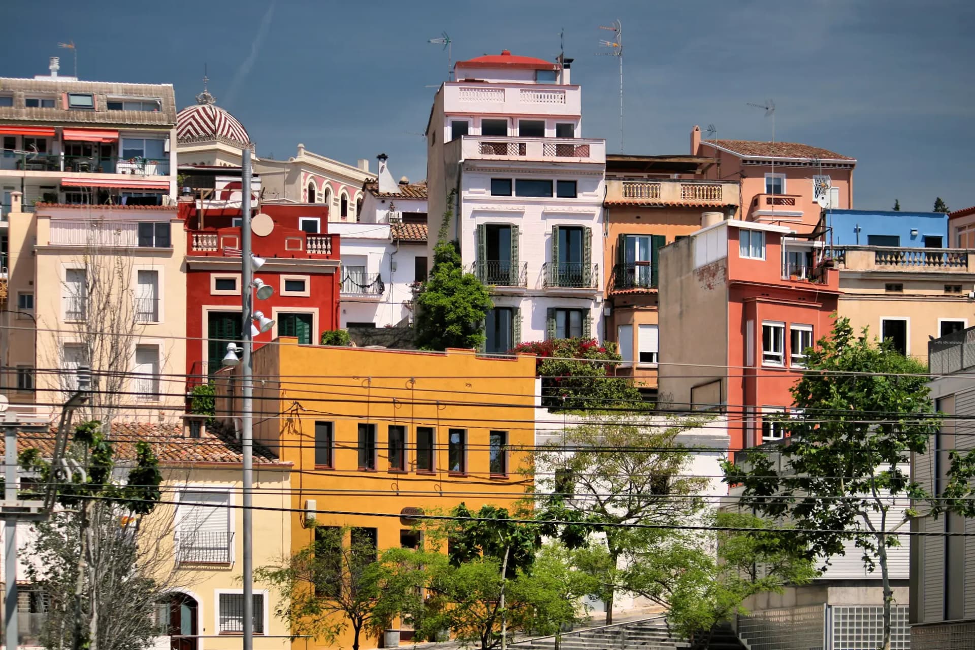 Casas de colores escalonadas entre árboles en El Masnou