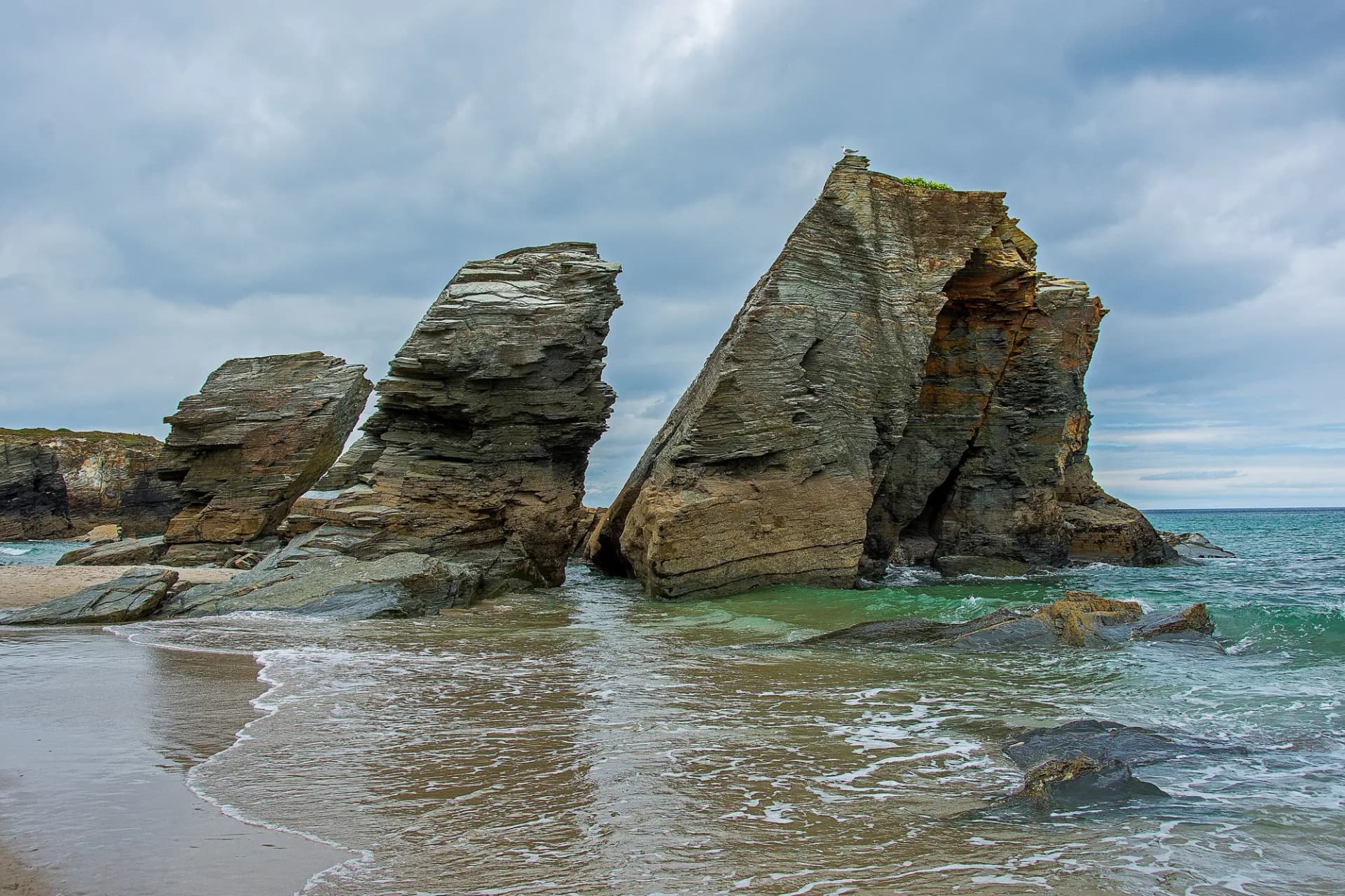 Grandes rocas de la playa de As Catedrais con el mar entrando en la arena